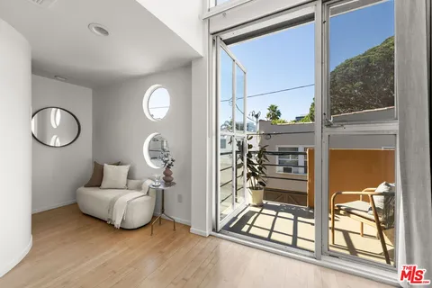 a living room with furniture and a mirror