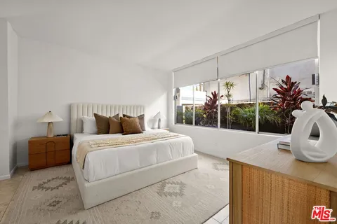 a bedroom with a large bed and a window