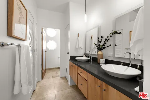 a bathroom with double sink and a mirror