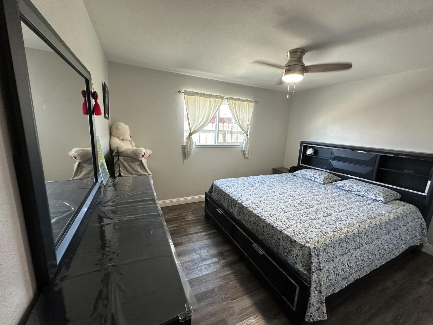 2160 Georgia Way Turlock, CA 95382 - Photo 18 of 25 a bedroom with a bed and wooden floor