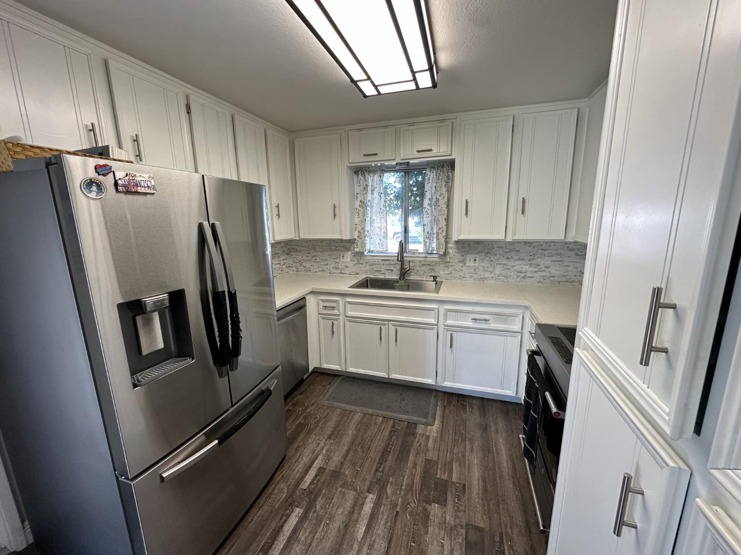 2160 Georgia Way Turlock, CA 95382 - Photo 20 of 25 a kitchen with stainless steel appliances a refrigerator a sink a stove and cabinets