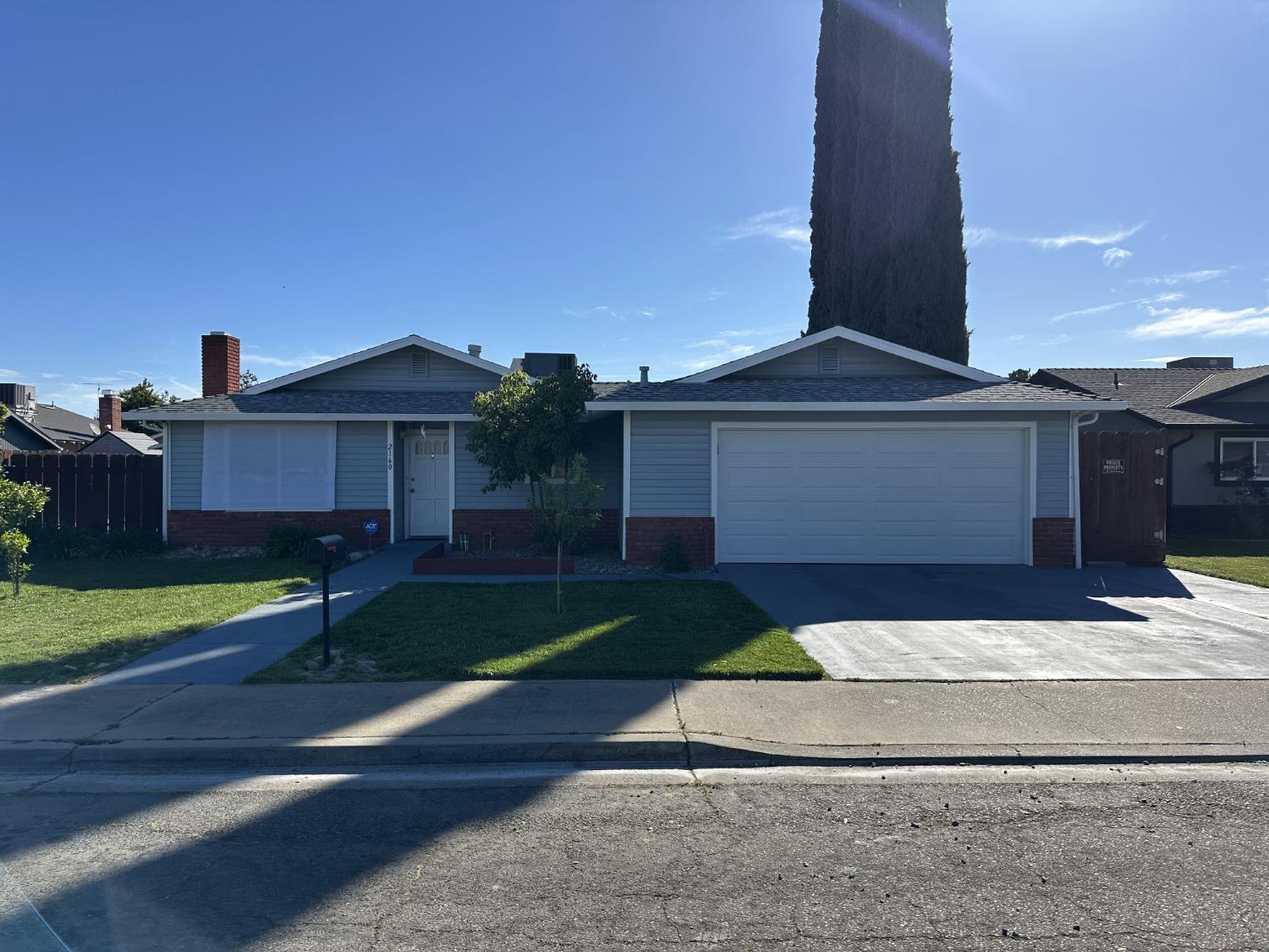 2160 Georgia Way Turlock, CA 95382 - Photo 2 of 25 a front view of a house with a yard and garage
