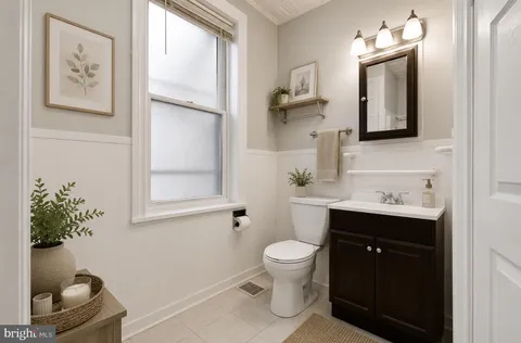 a bathroom with a toilet sink and mirror