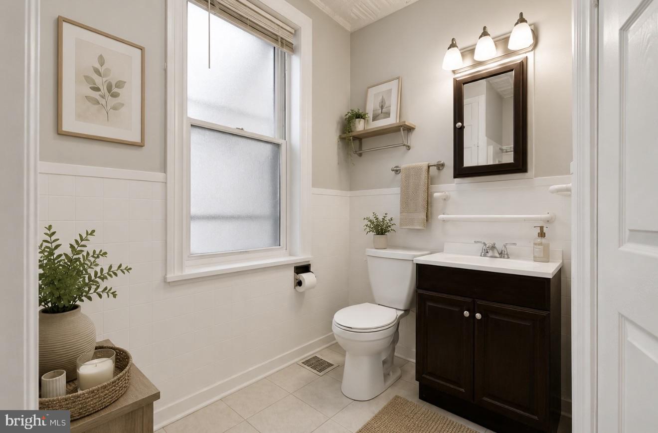 4817 Ridge Avenue Philadelphia, PA 19129 - Photo 9 of 34 a bathroom with a toilet sink and mirror