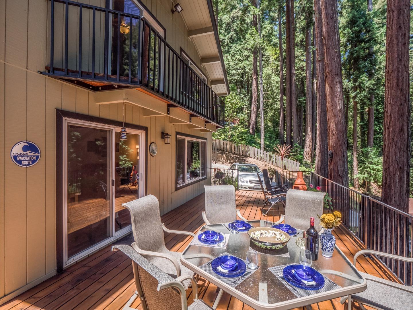 10270 Alba Road Ben Lomond, CA 95005 - Photo 21 of 41 a view of a patio with couches table and chairs and potted plants