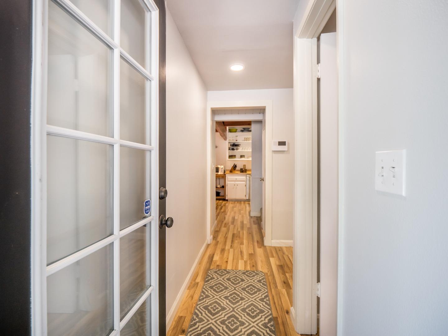 10270 Alba Road Ben Lomond, CA 95005 - Photo 34 of 41 a view of a hallway with wooden floor and staircase