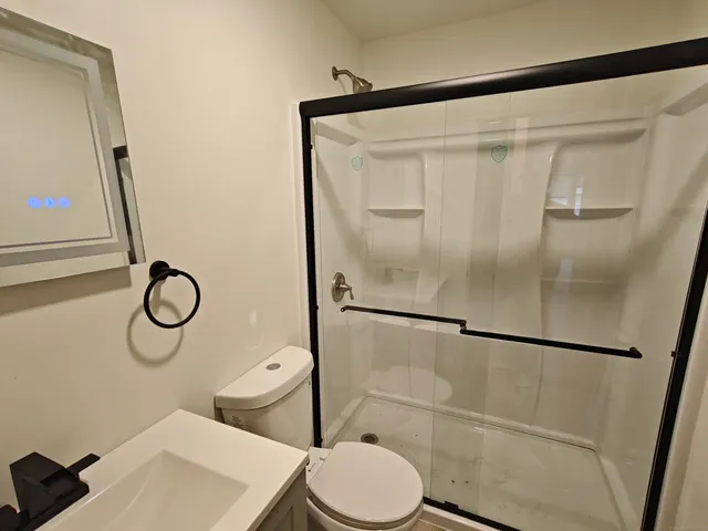 a white toilet sitting next to a bathroom sink