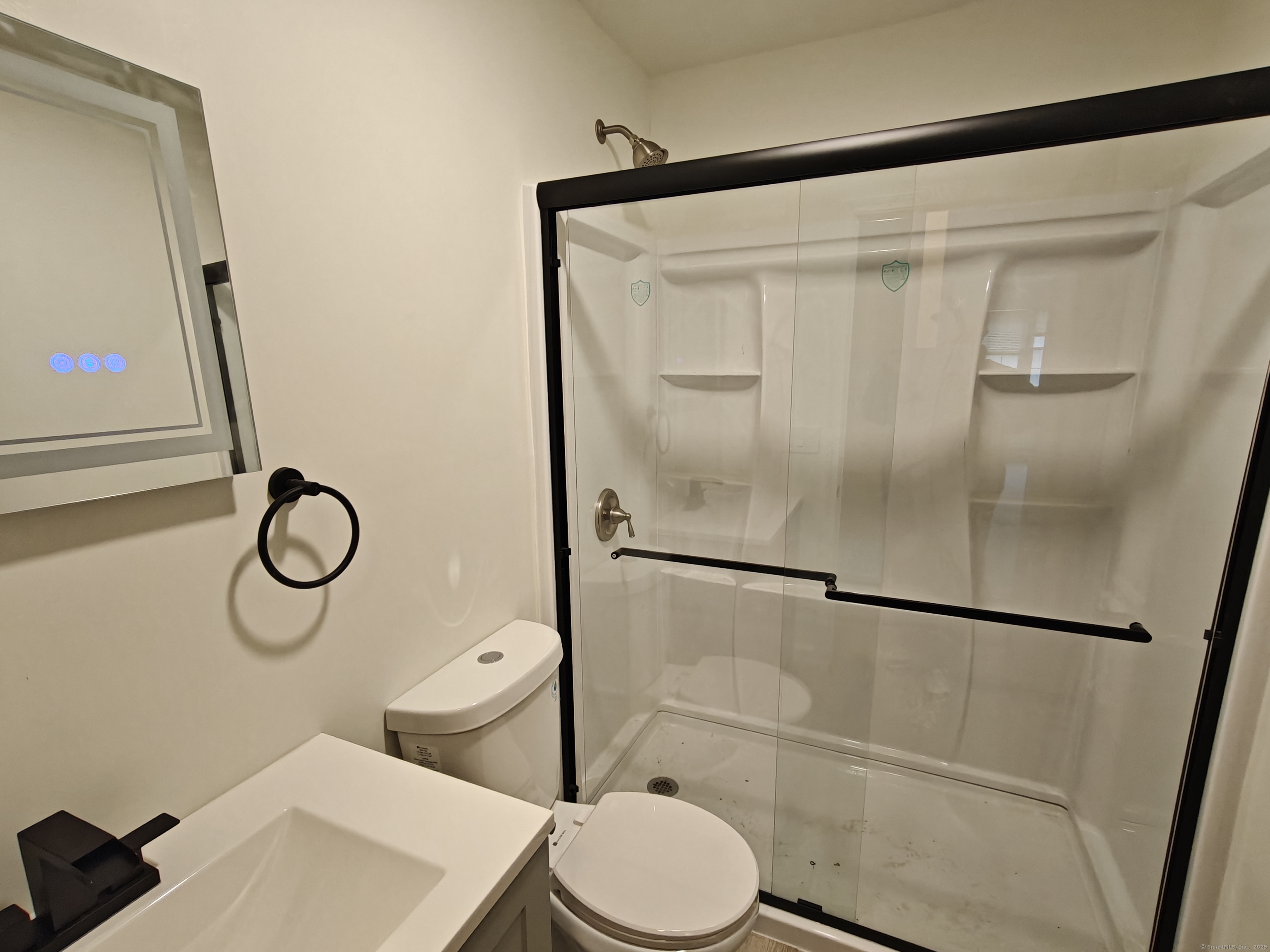 18 Broadview Heights, Unit C Thomaston, CT 06787 - Photo 11 of 15 a white toilet sitting next to a bathroom sink