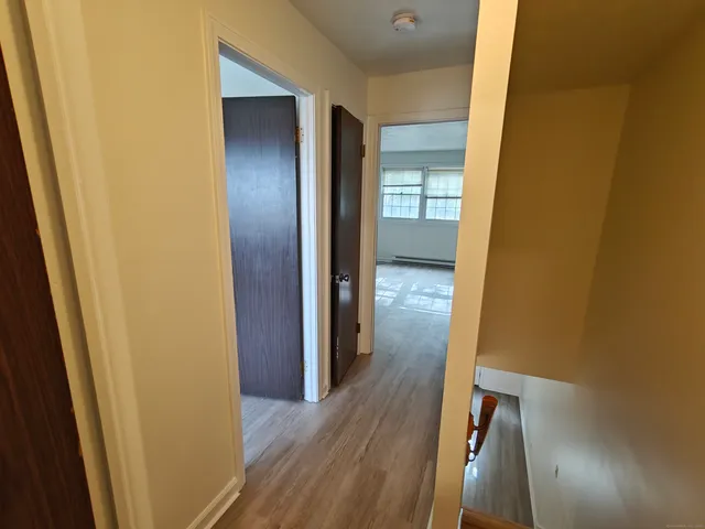 an empty room with wooden floor and closet