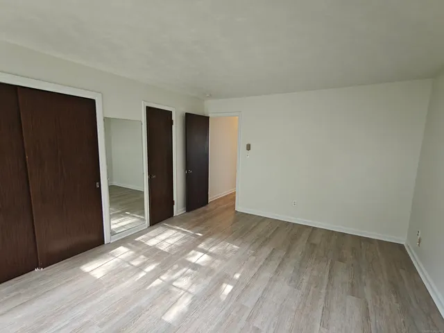 a view of an empty room and wooden floor
