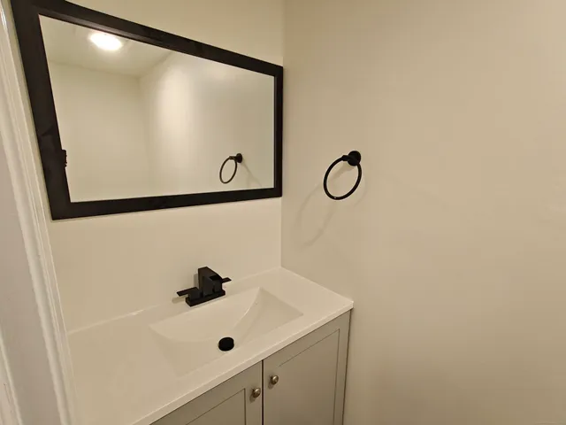 a bathroom with a shower and mirror