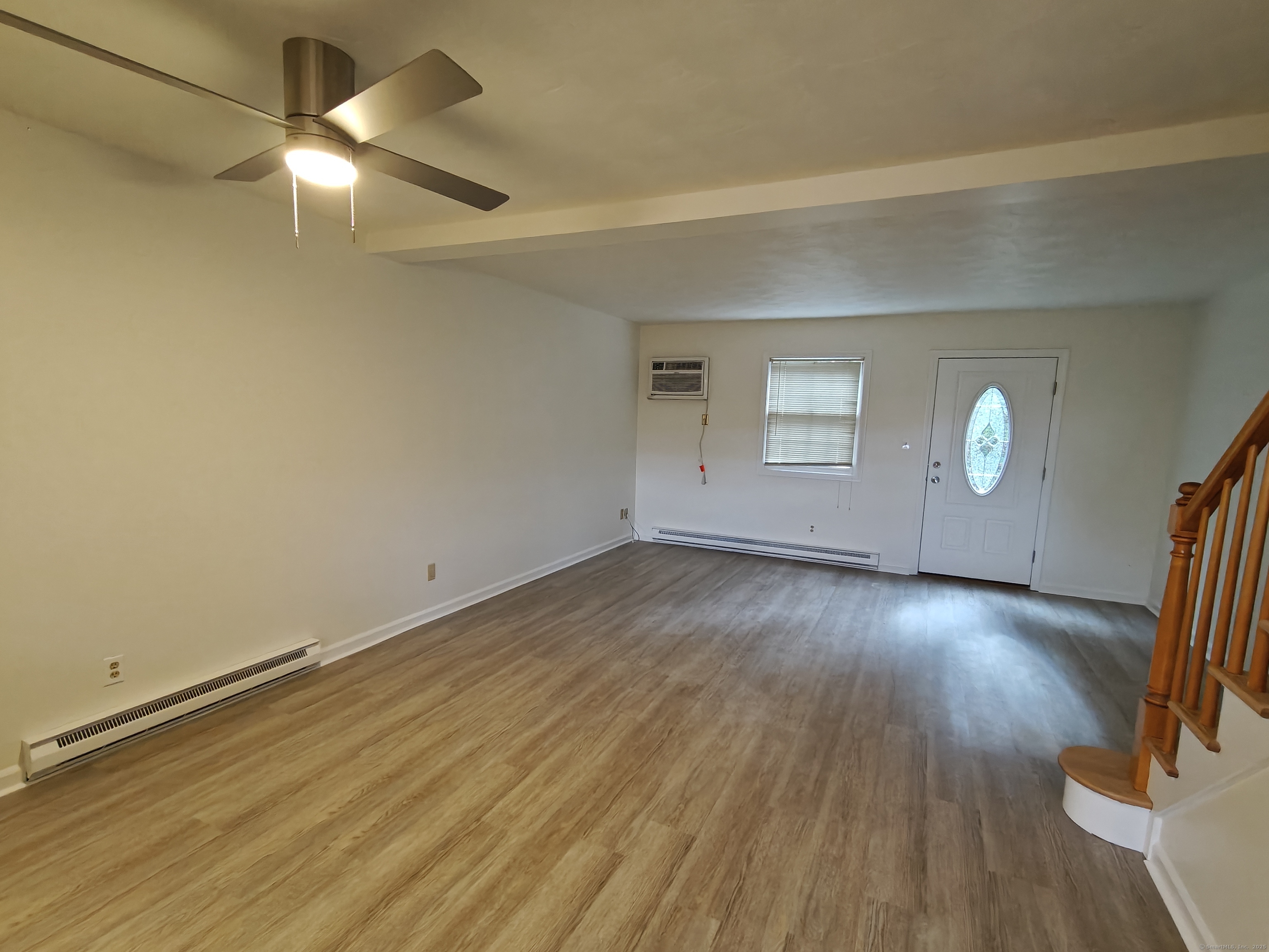 18 Broadview Heights, Unit C Thomaston, CT 06787 - Photo 7 of 15 an empty room with wooden floor and windows