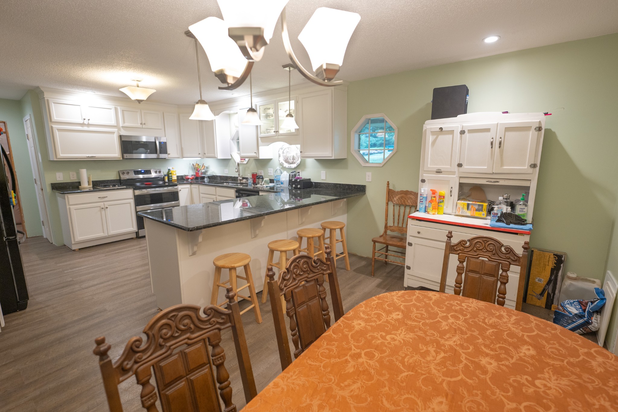 757 Bryson Road Ardmore, TN 38449 - Photo 12 of 40 a kitchen with stainless steel appliances a dining table chairs stove and cabinets