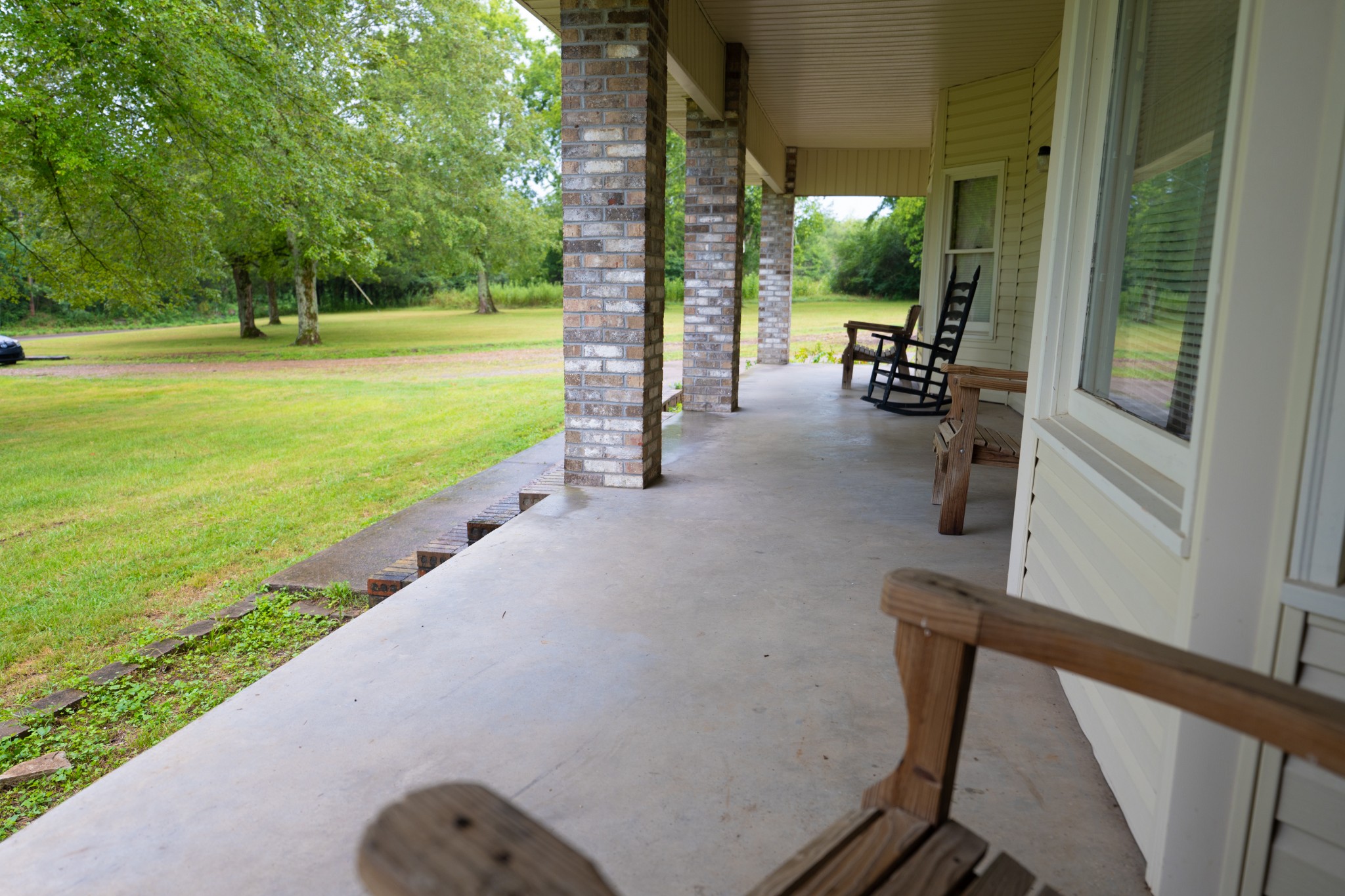 757 Bryson Road Ardmore, TN 38449 - Photo 38 of 40 a view of a patio with lawn chairs floor to ceiling window and yard