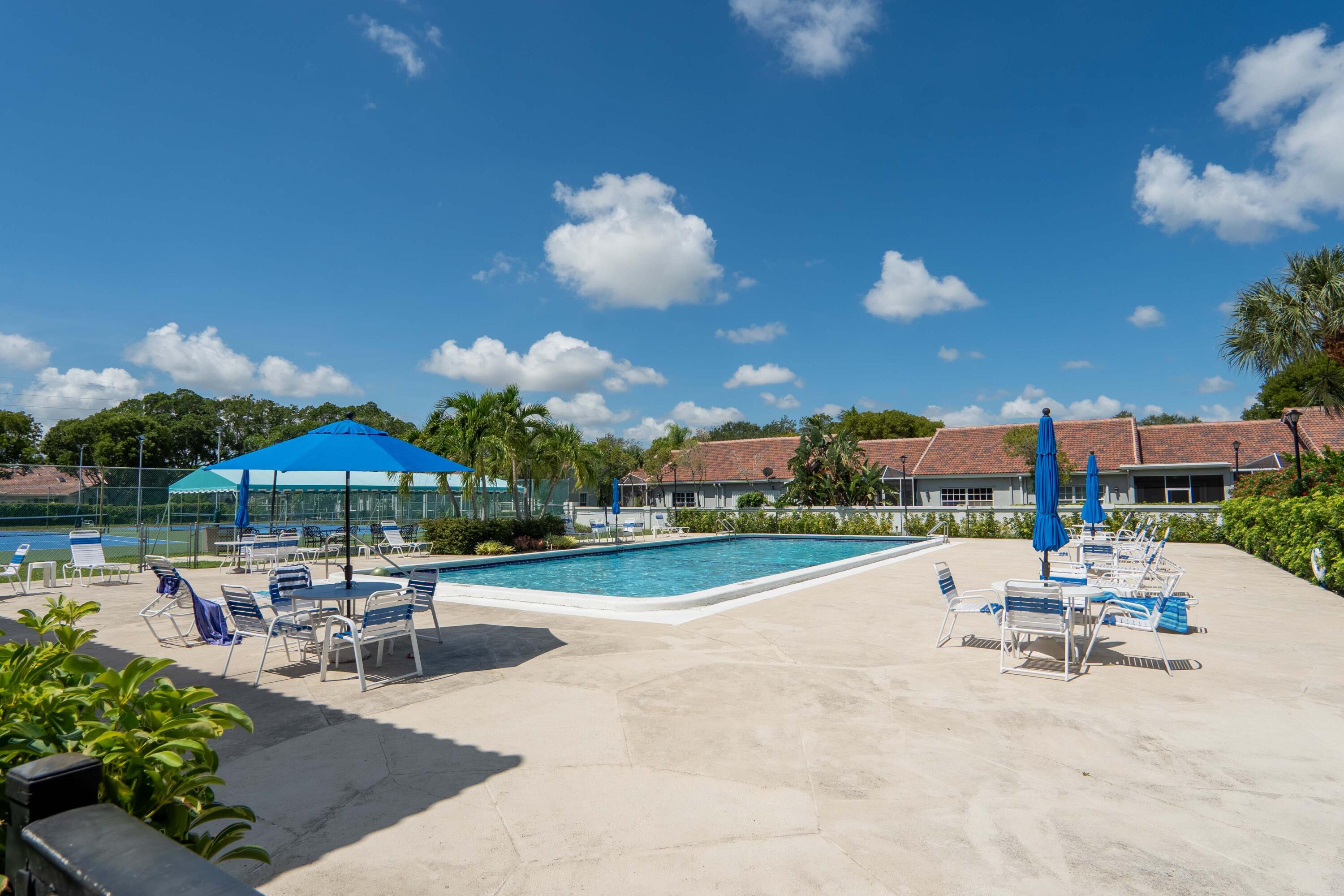 5260 Northwest 2nd Avenue, Unit 105 Boca Raton, FL 33487 - Photo 23 of 24 a view of a patio with a table and chairs under an umbrella