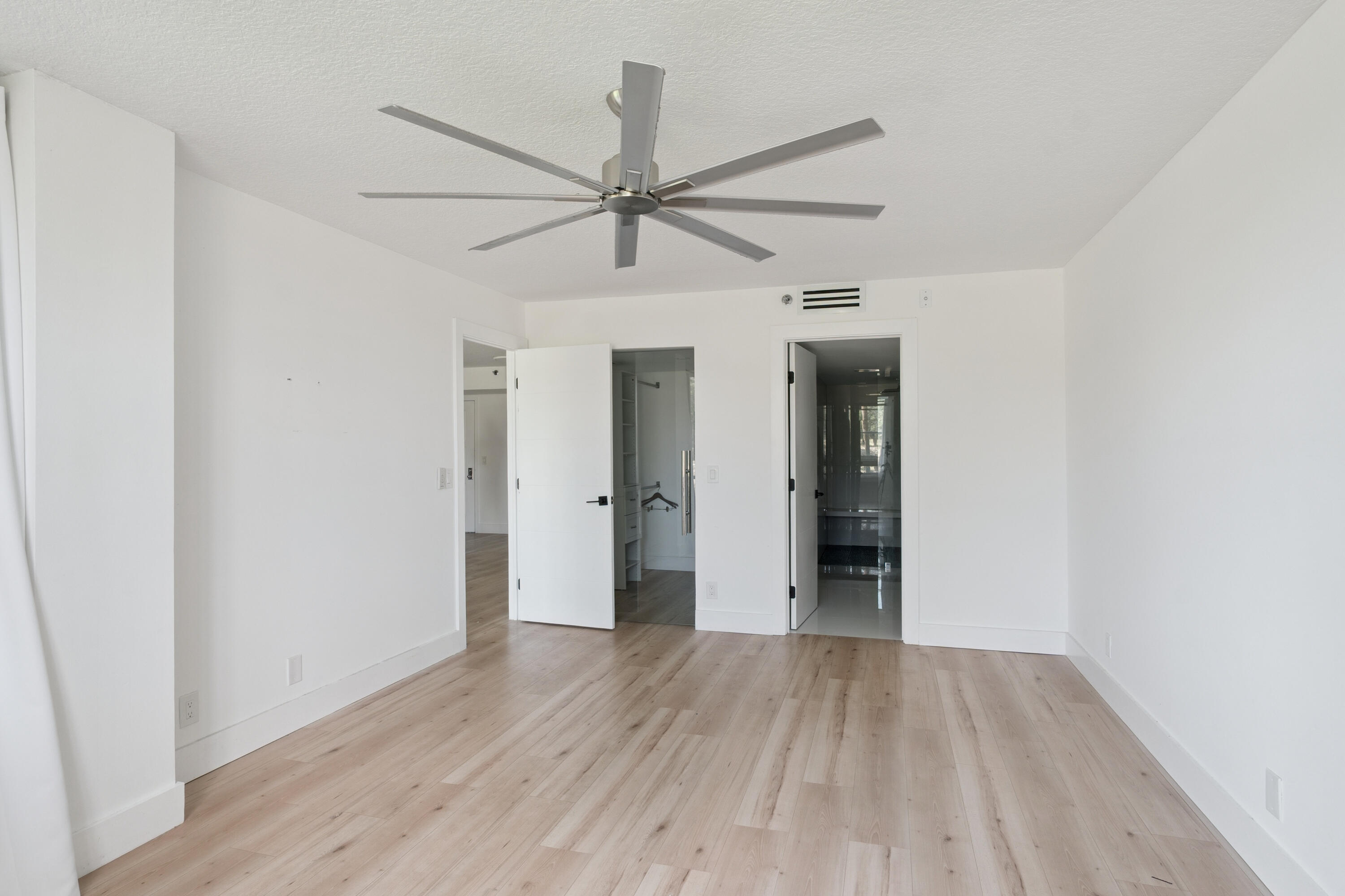 5260 Northwest 2nd Avenue, Unit 105 Boca Raton, FL 33487 - Photo 9 of 24 a view of an empty room with wooden floor