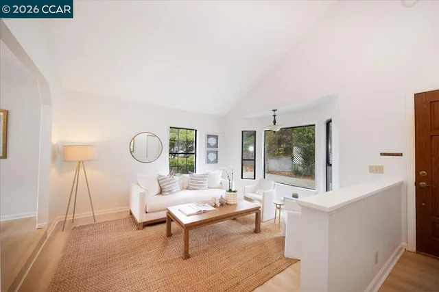 a living room with furniture a rug and a large window