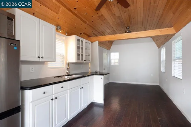 a view of a house with a yard patio and a tree