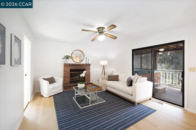 a living room with furniture a fireplace and a chandelier