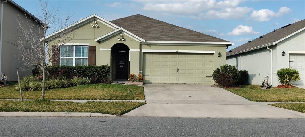 1909 Partin Terrace Road Kissimmee, FL 34744 - Photo 1 of 1 a front view of a house with garage