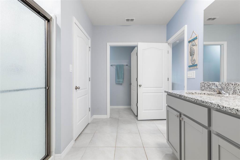 277 Sunset Point Drive Ormond Beach, FL 32174 - Photo 25 of 52 a bathroom with a granite countertop sink and a mirror