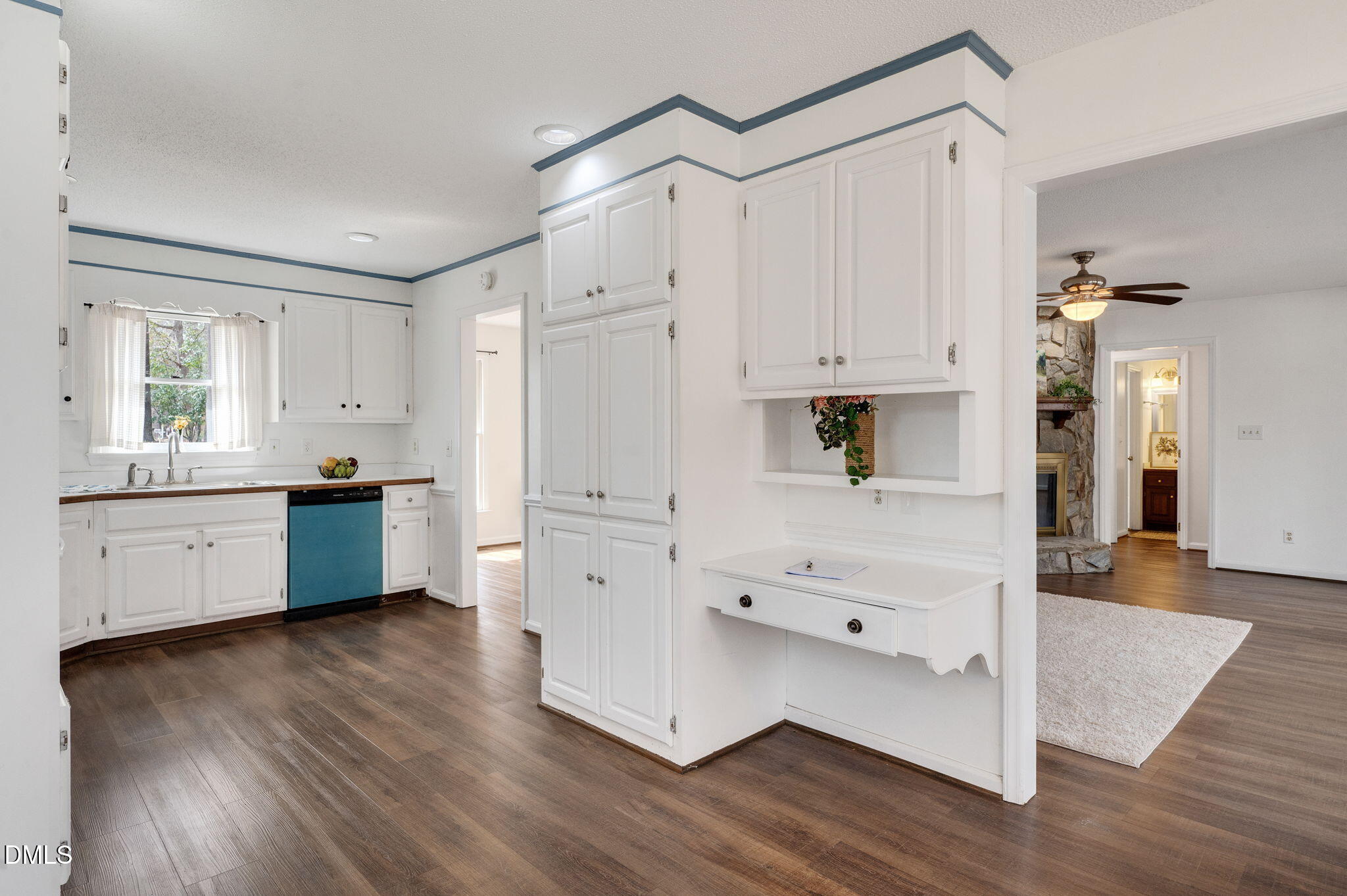9205 Tree Meadow Lane Raleigh, NC 27603 - Photo 10 of 44 a kitchen with white cabinets and white appliances