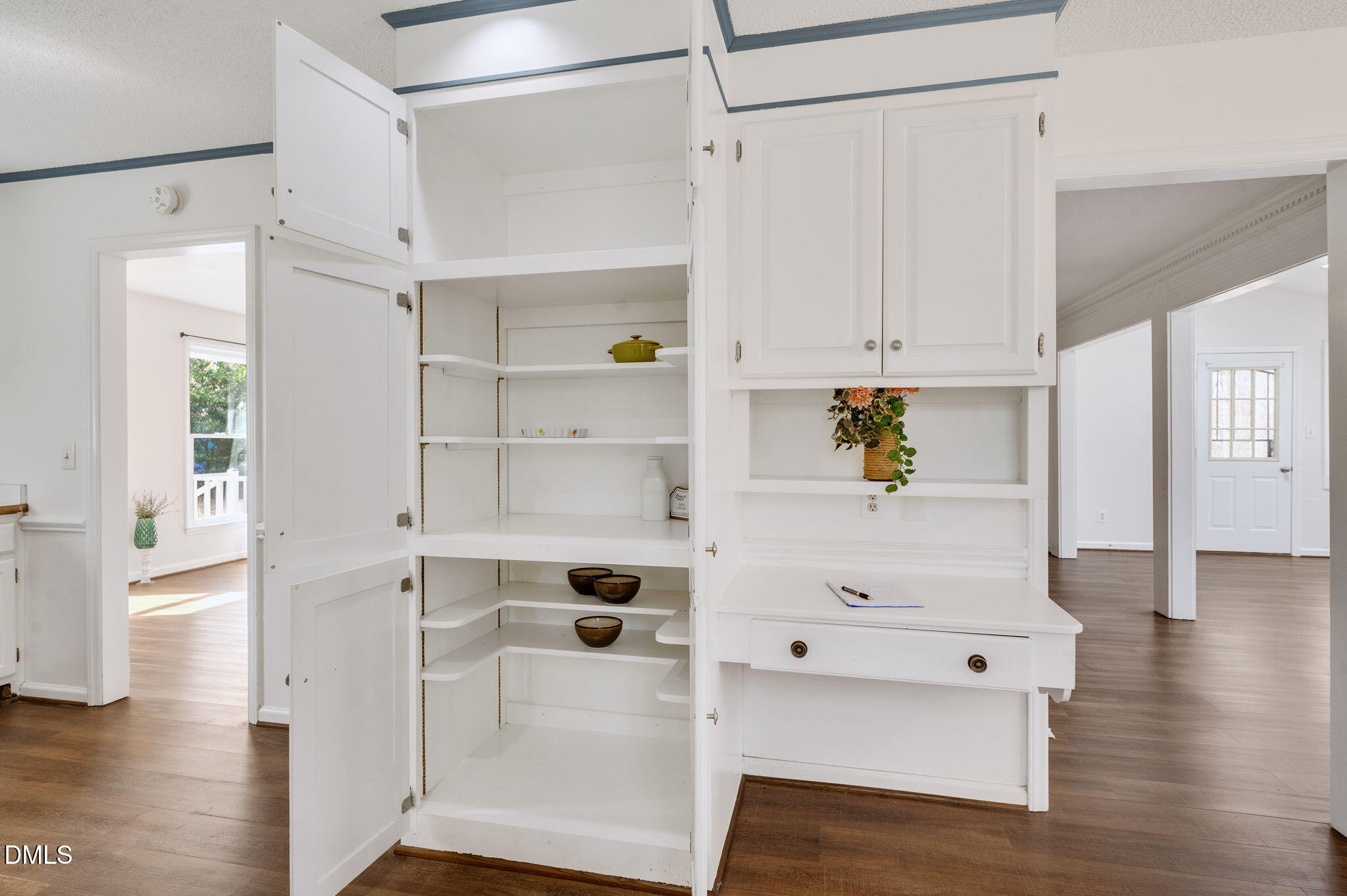 9205 Tree Meadow Lane Raleigh, NC 27603 - Photo 11 of 44 a view of kitchen with white wooden cabinets and wooden floor