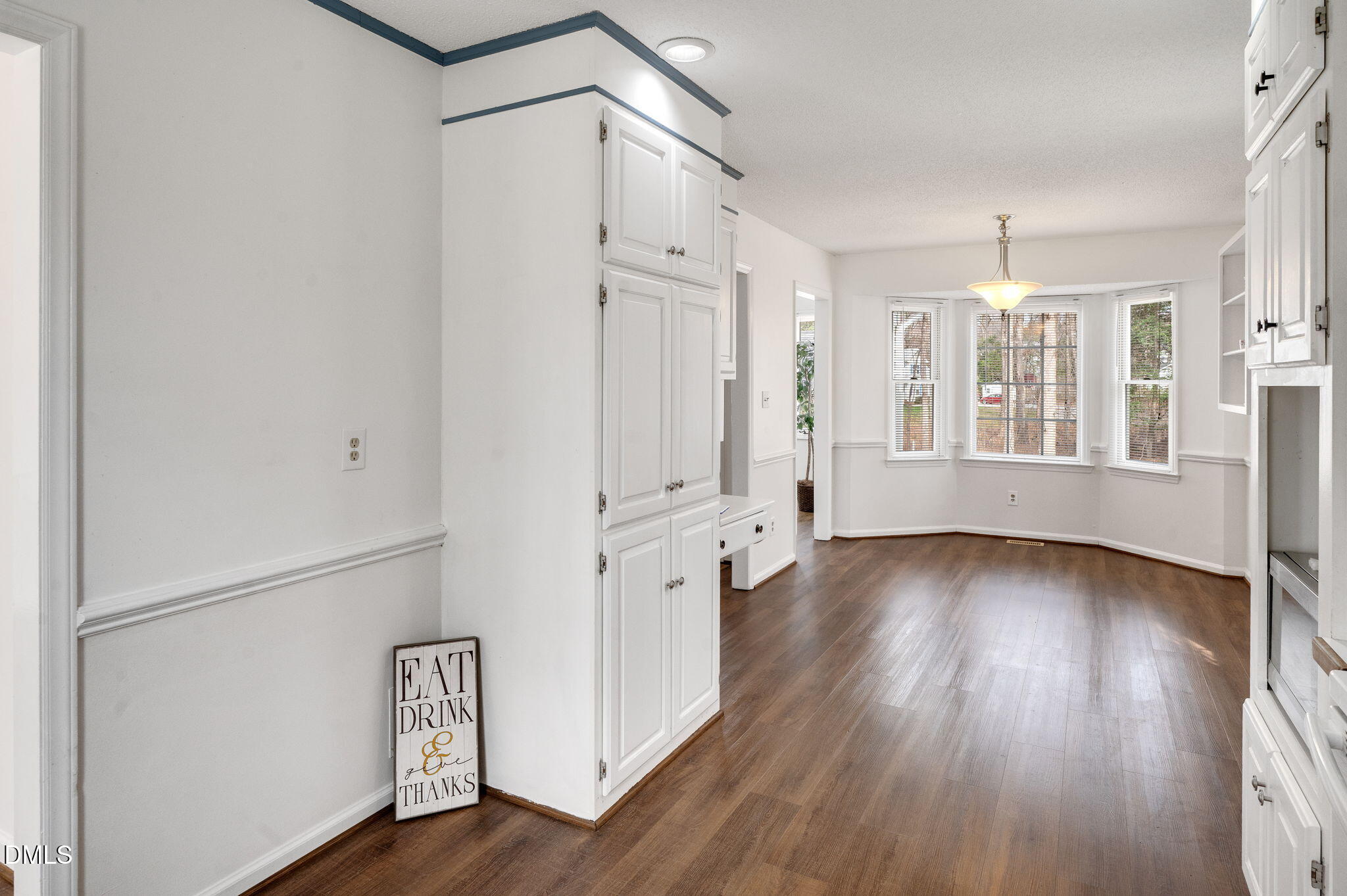 9205 Tree Meadow Lane Raleigh, NC 27603 - Photo 12 of 44 an empty room with wooden floor and windows