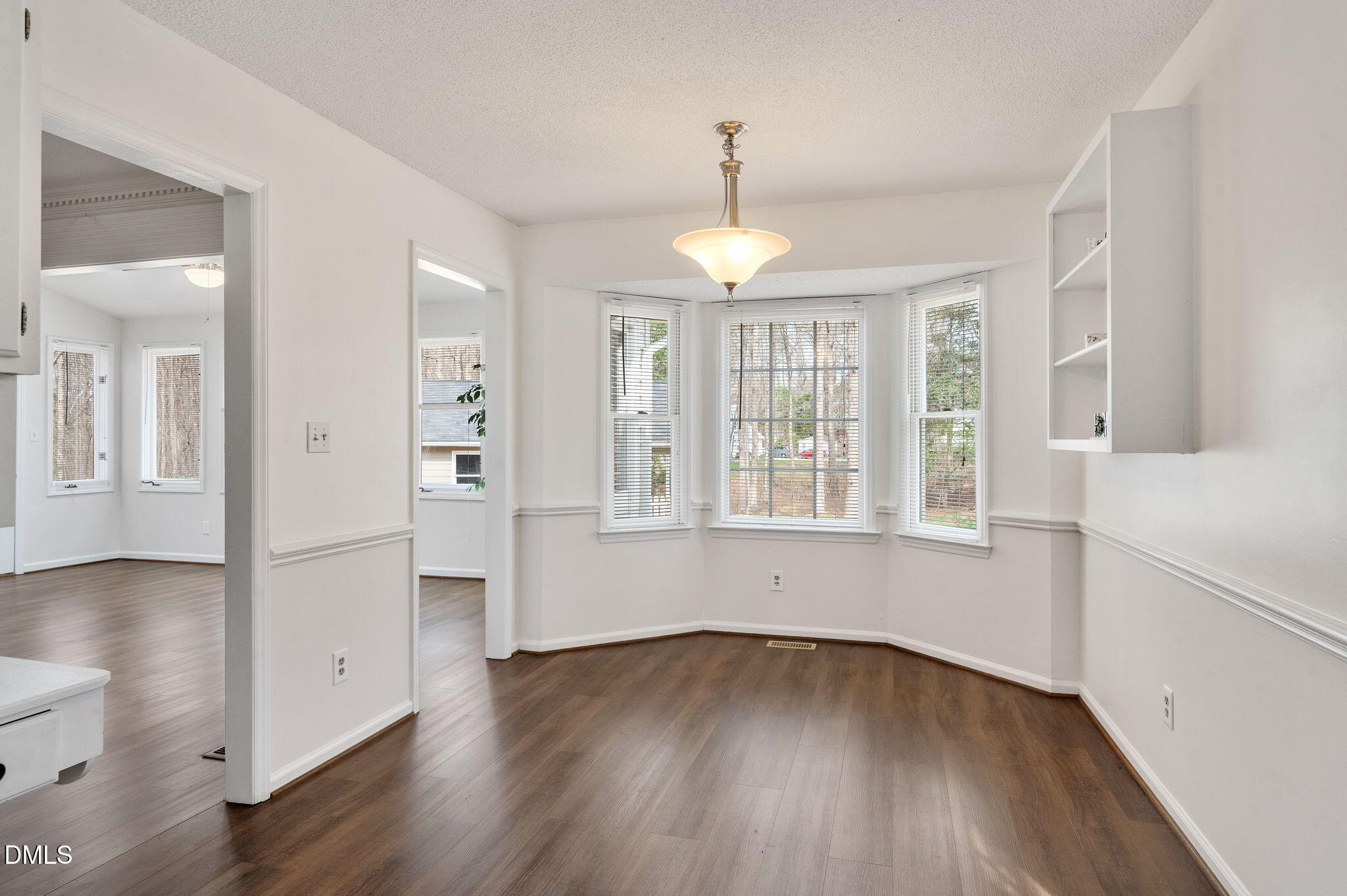 9205 Tree Meadow Lane Raleigh, NC 27603 - Photo 14 of 44 an empty room with wooden floor and windows