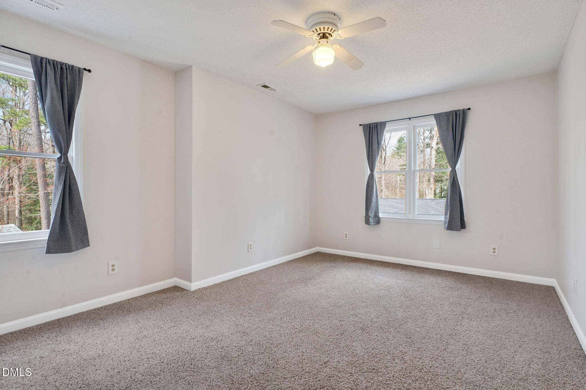 9205 Tree Meadow Lane Raleigh, NC 27603 - Photo 28 of 44 an empty room with windows and fan