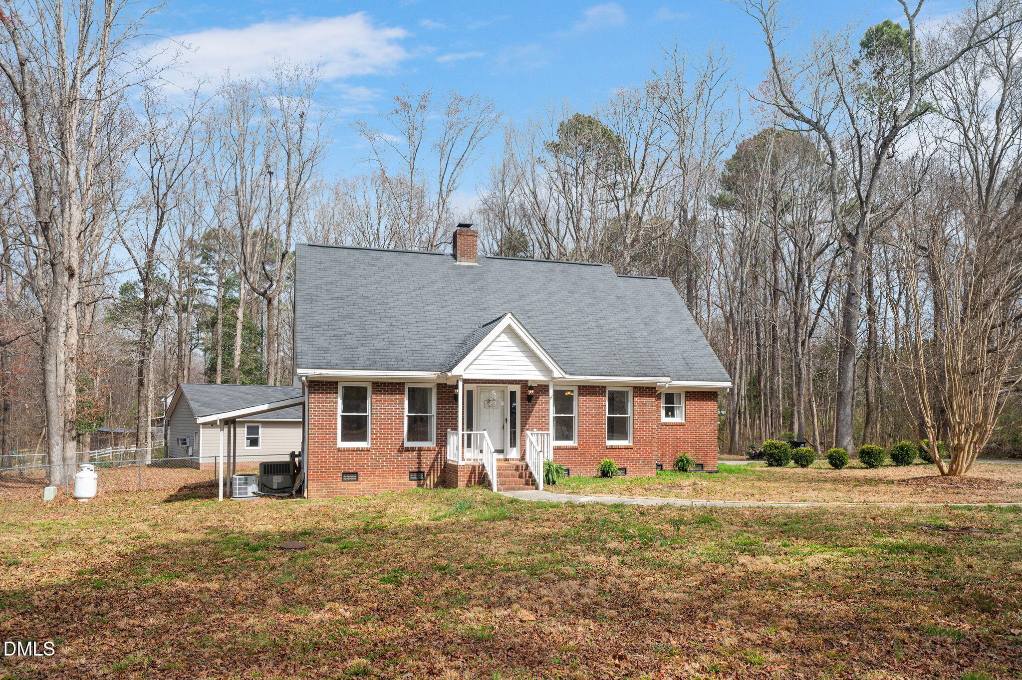 9205 Tree Meadow Lane Raleigh, NC 27603 - Photo 2 of 44 a view of a big house with a big yard and large trees