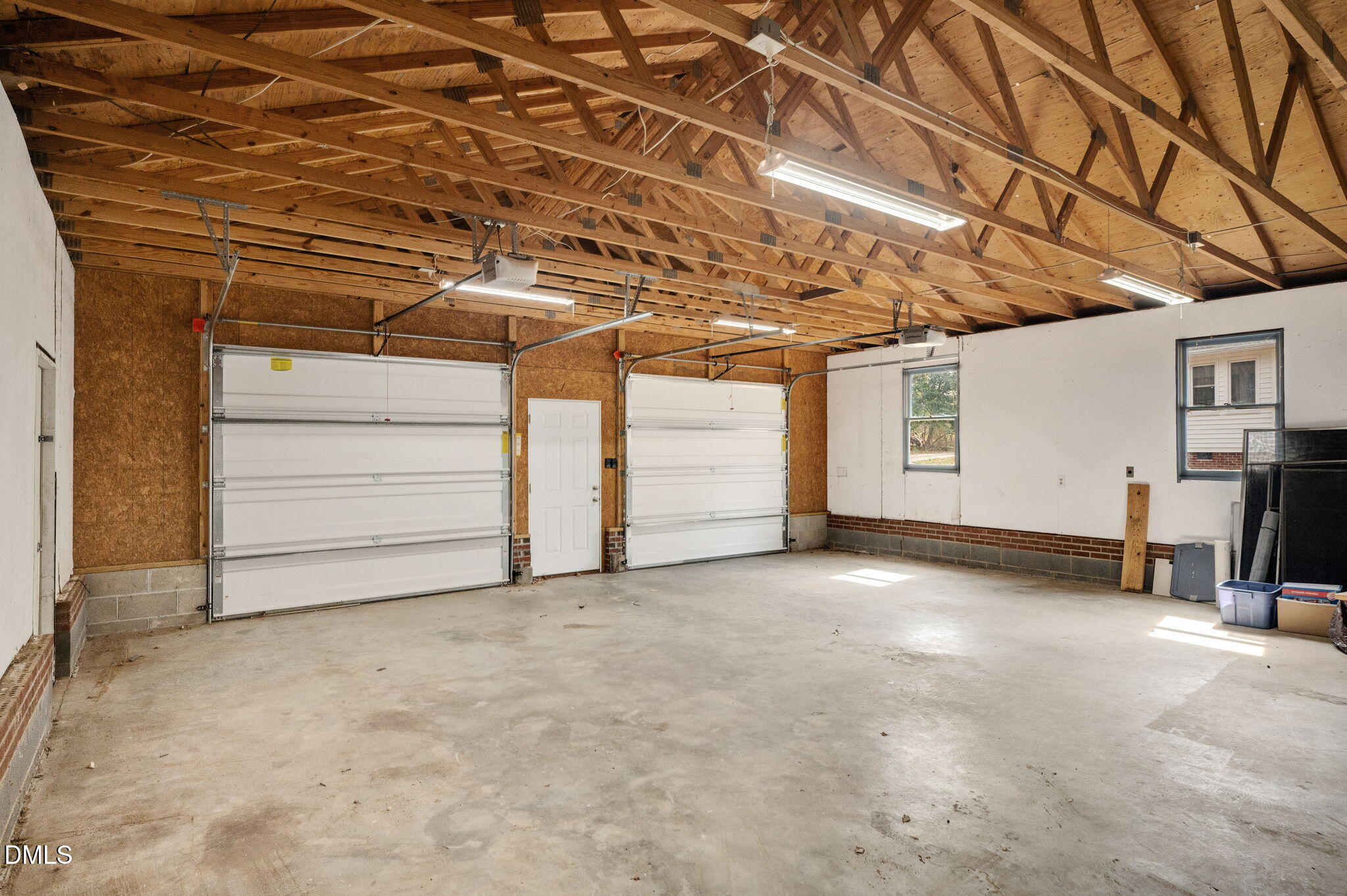 9205 Tree Meadow Lane Raleigh, NC 27603 - Photo 39 of 44 a view of a room with furniture and a garage