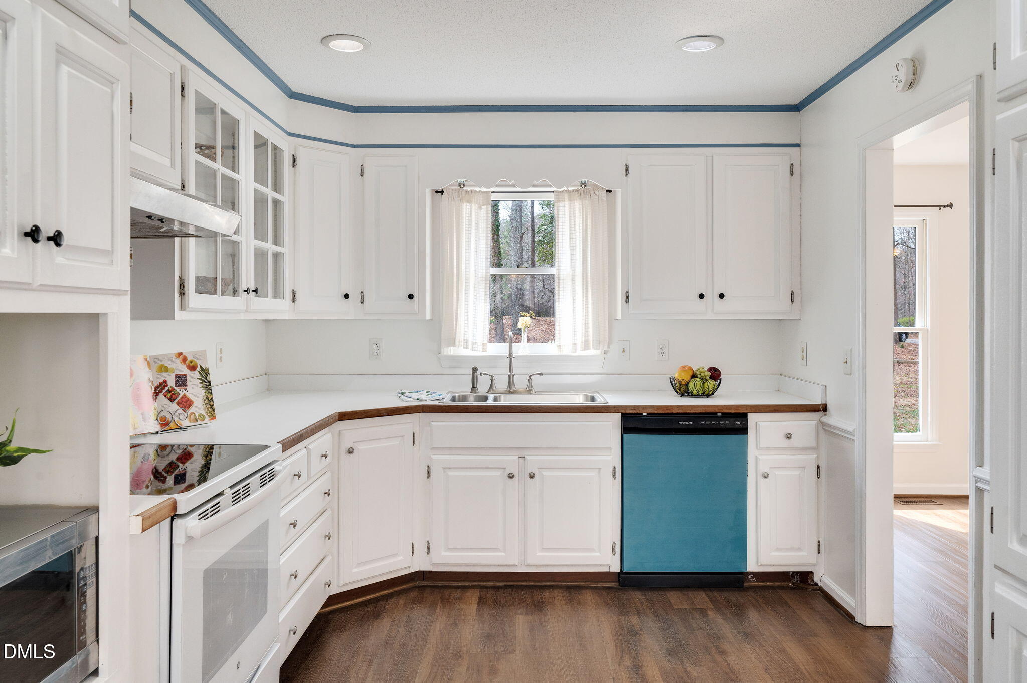9205 Tree Meadow Lane Raleigh, NC 27603 - Photo 8 of 44 a kitchen with granite countertop white cabinets and white appliances