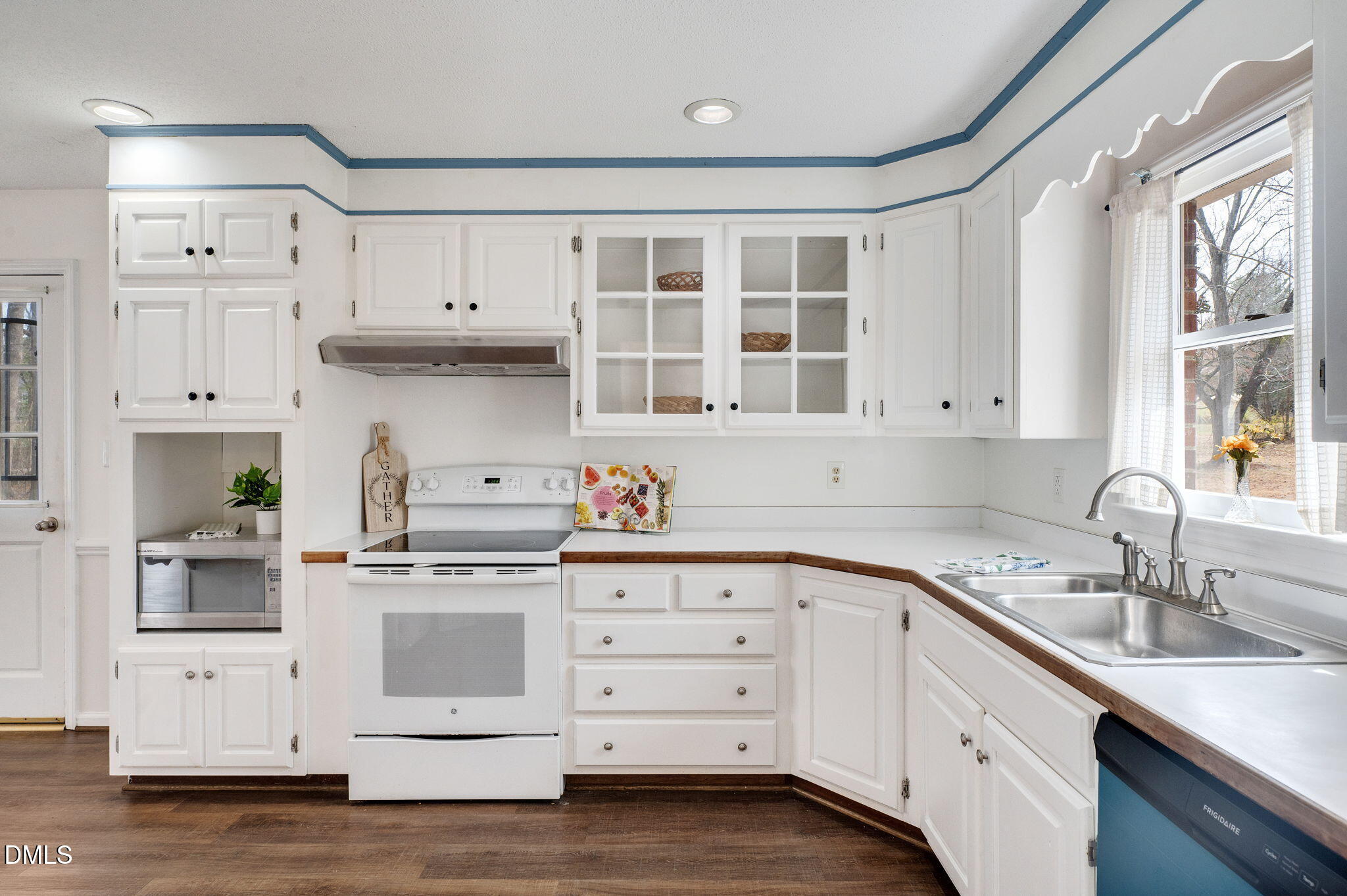 9205 Tree Meadow Lane Raleigh, NC 27603 - Photo 9 of 44 a kitchen with granite countertop white cabinets and white appliances