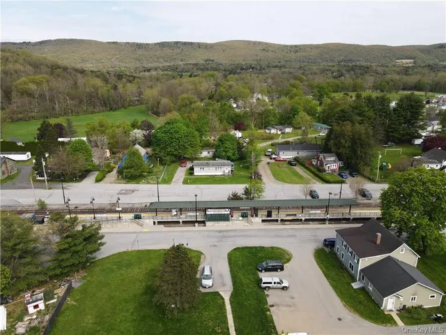 an aerial view of residential house with outdoor space and mountain view