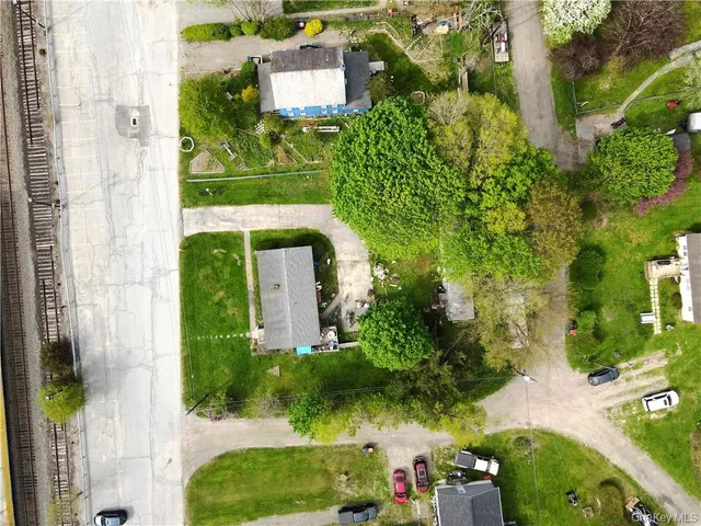 an aerial view of a house with a yard