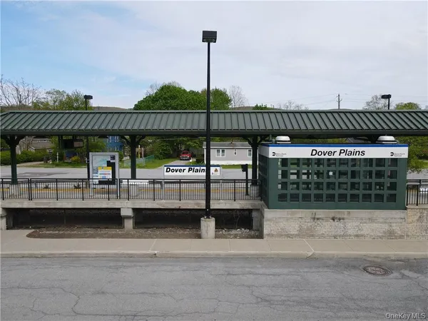 a view of a patio with couches and wooden fence