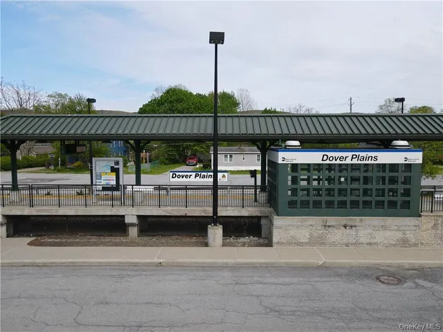 a view of a patio with couches and wooden fence