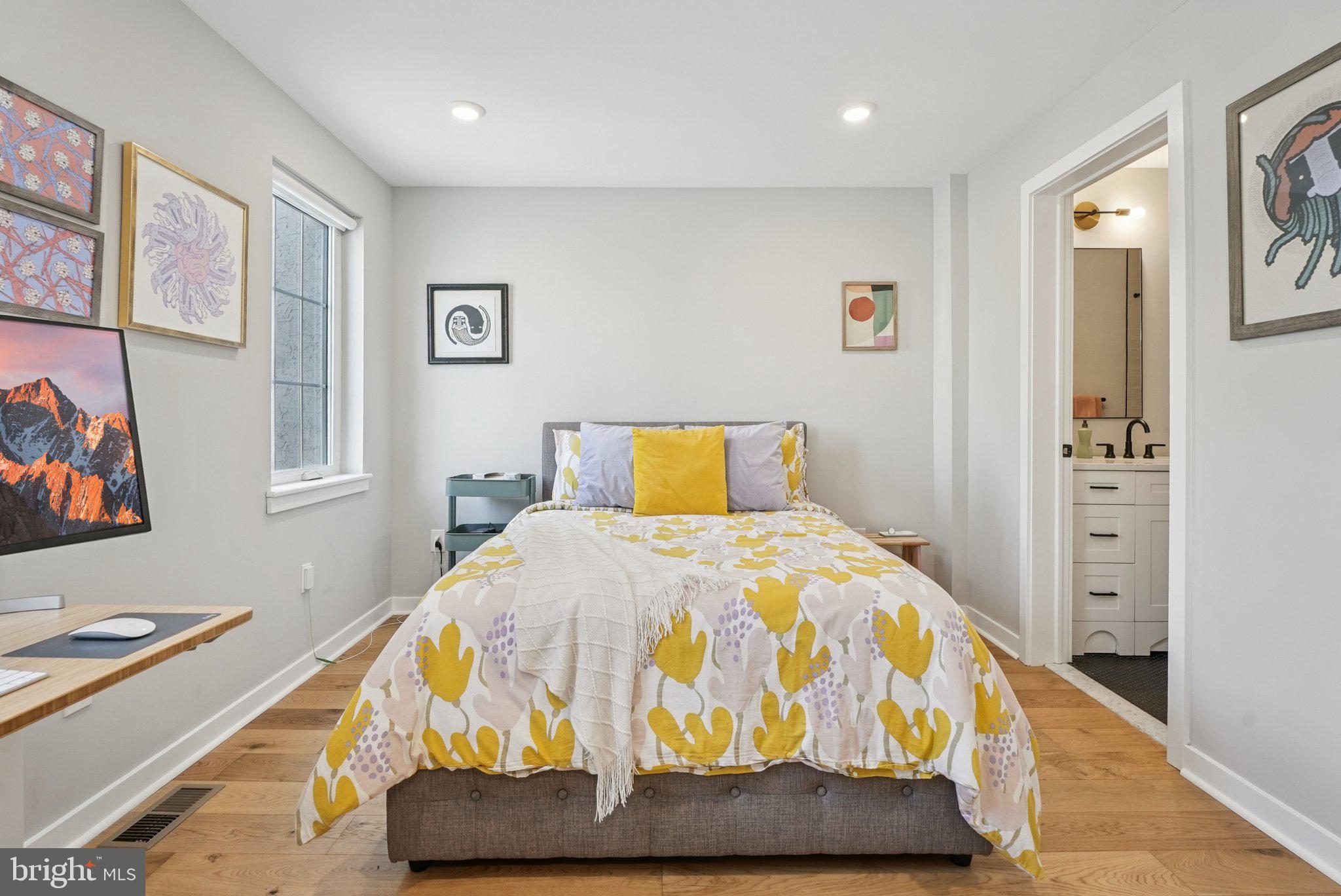 919 Reed Street Philadelphia, PA 19147 - Photo 13 of 28 a bedroom with a bed and wooden floor