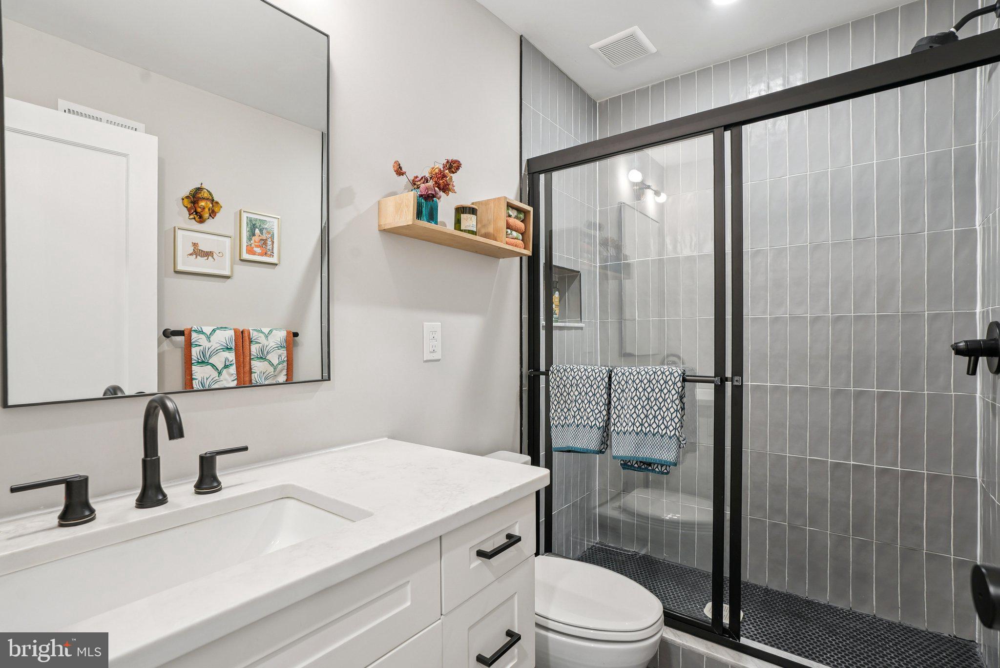 919 Reed Street Philadelphia, PA 19147 - Photo 17 of 28 a bathroom with a sink a toilet and shower