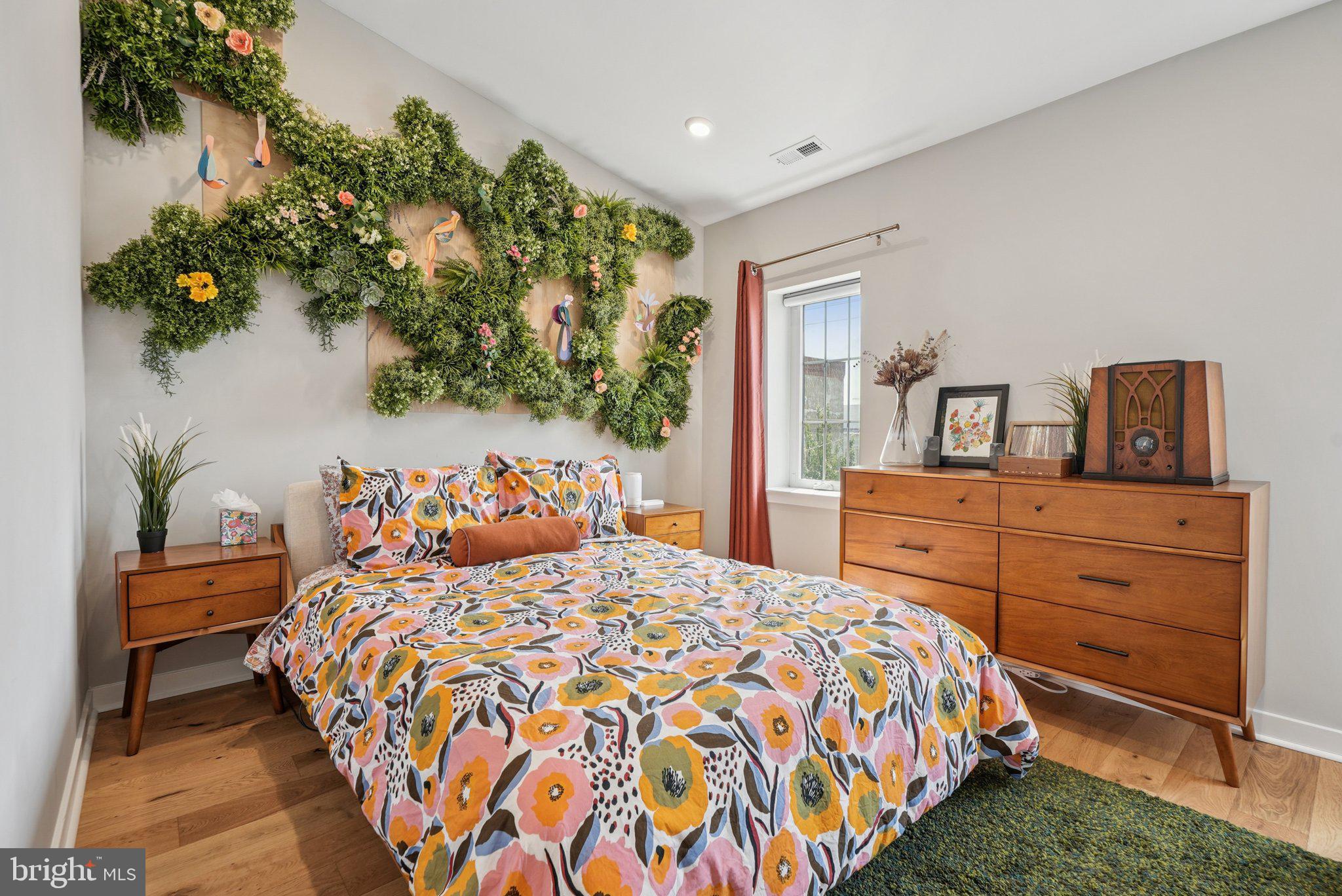 919 Reed Street Philadelphia, PA 19147 - Photo 19 of 28 a bedroom with a large bed and a potted plant