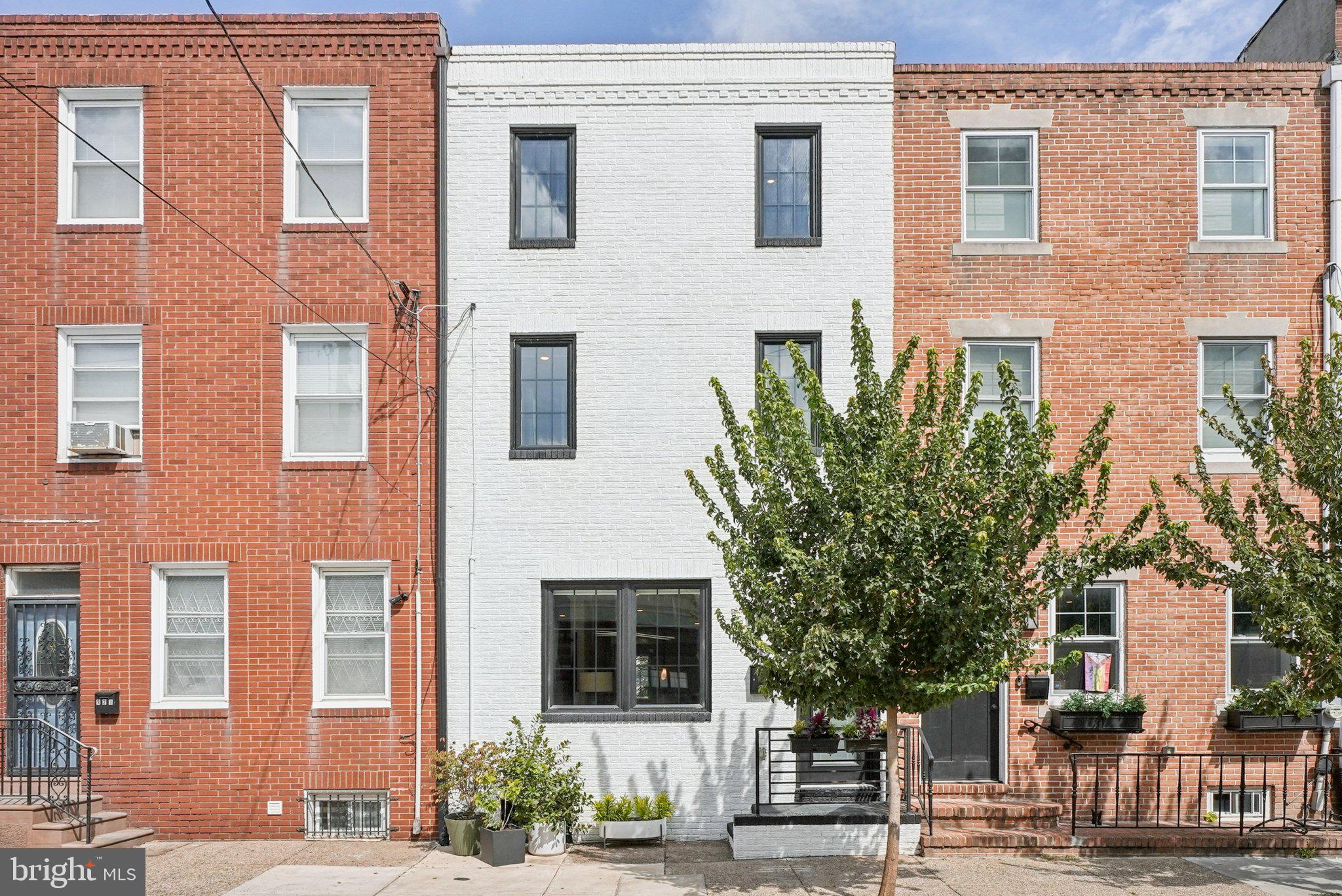 919 Reed Street Philadelphia, PA 19147 - Photo 2 of 28 a front view of a building with a garden
