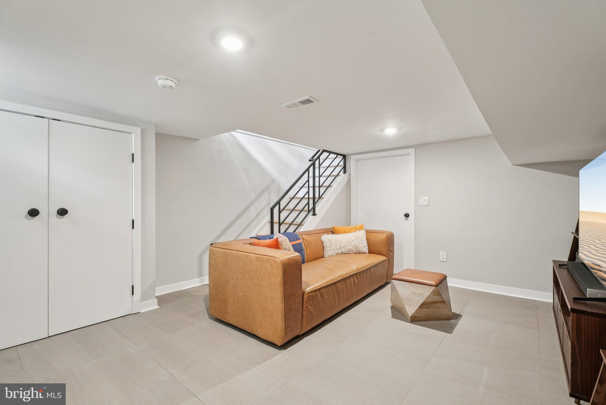919 Reed Street Philadelphia, PA 19147 - Photo 25 of 28 a living room with furniture and a ceiling fan