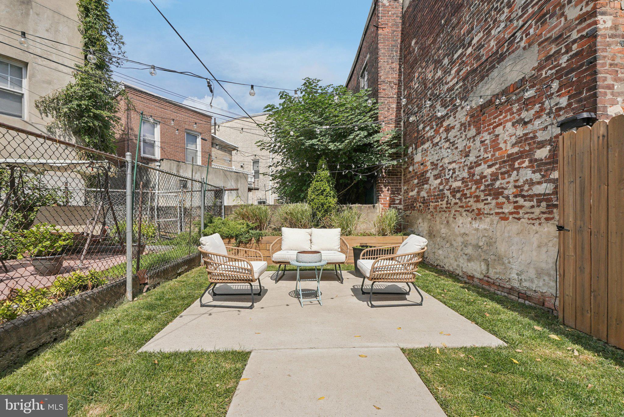 919 Reed Street Philadelphia, PA 19147 - Photo 27 of 28 a view of backyard of house with outdoor seating