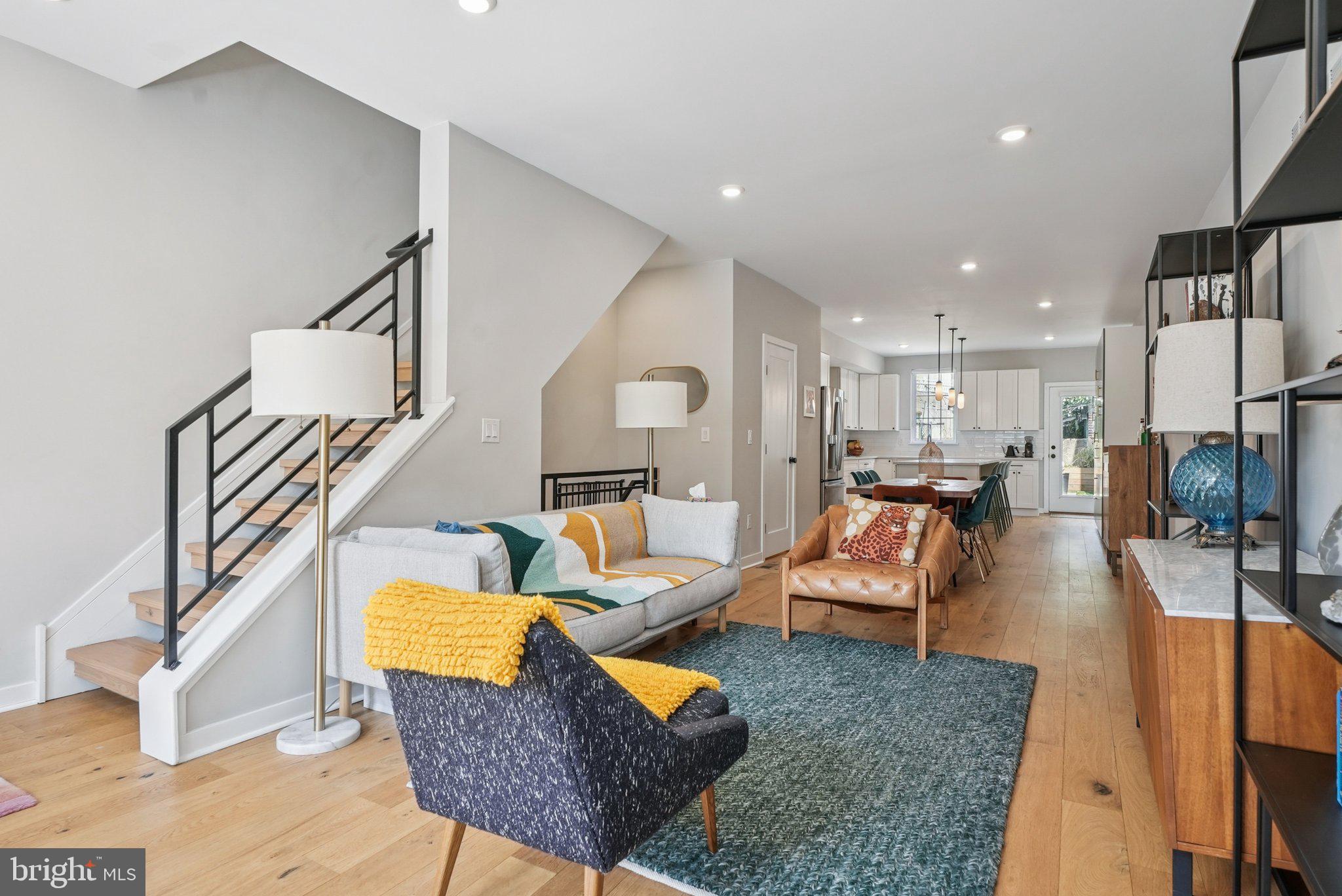 919 Reed Street Philadelphia, PA 19147 - Photo 4 of 28 a living room with furniture kitchen view and a wooden floor