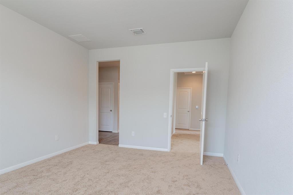 14614 Frankel Loop Pflugerville, TX 78660 - Photo 6 of 15 A spacious room offers comfortable carpeting, ready for personalization.