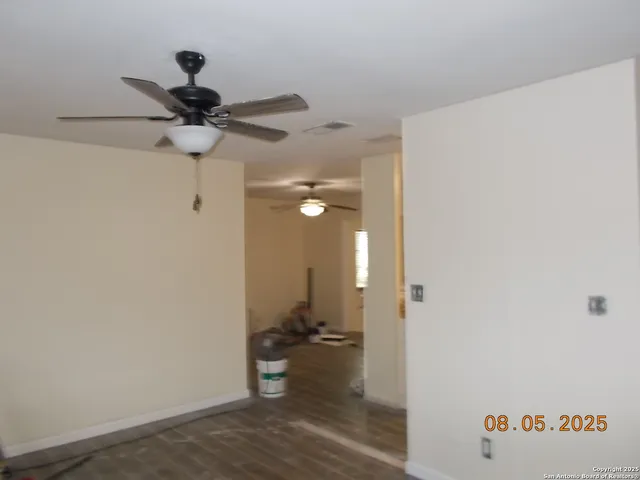a kitchen with a refrigerator and a stove top oven