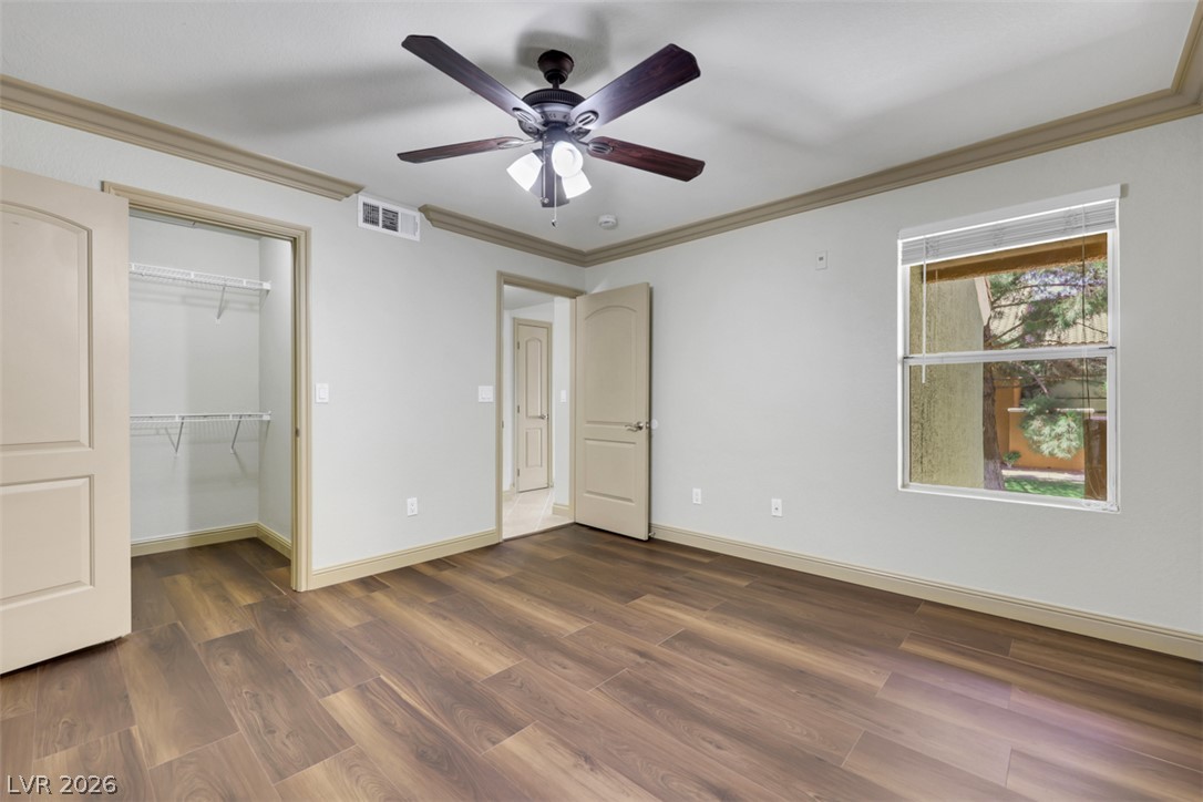 8101 West Flamingo Road, Unit 2136 Las Vegas, NV 89147 - Photo 27 of 32 Rich wood-look flooring and classic crown molding define this comfortable secondary bedroom.