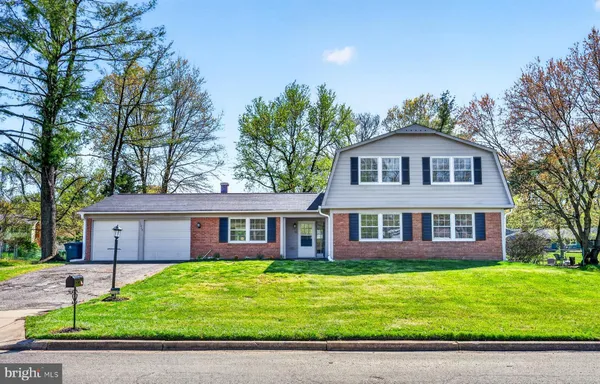 a front view of a house with a garden and yard