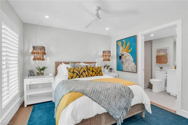 a bedroom with a bed and a painting on the wall